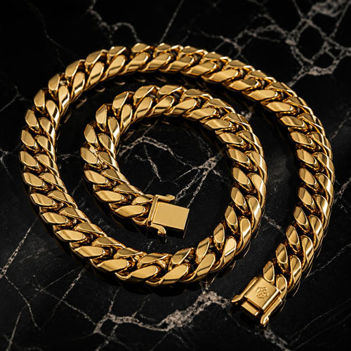 Gold Cuban link chain on black marble